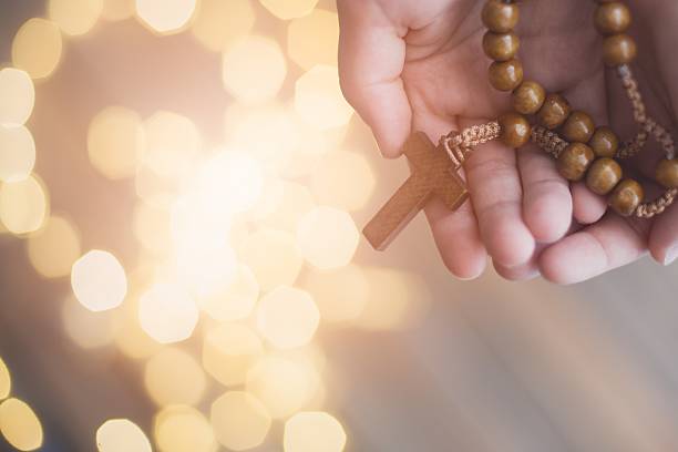 Little boy child praying and holding wooden rosary. More from this series in my portfolioLittle boy child praying and holding wooden rosary. More from this series in my portfolio